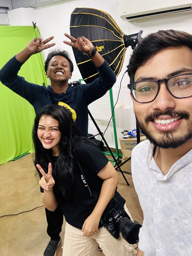 Behind the scenes on a shoot day with the content crew, softbox and camera in frame